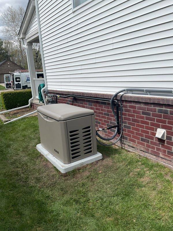 Completed installation of a 20kW RCA standby generator with 100-amp automatic transfer switch on exterior concrete pad with proper conduit routing along foundation to interior electrical panel. All required permits obtained including mechanical, electrical, generator, gas piping, and pressure testing approvals prior to installation. Installed transfer switch in basement utility area with appropriate wiring connections to main electrical panel, completed gas line installation and pressure testing, and verified proper operation of automatic transfer system upon utility power loss simulation.