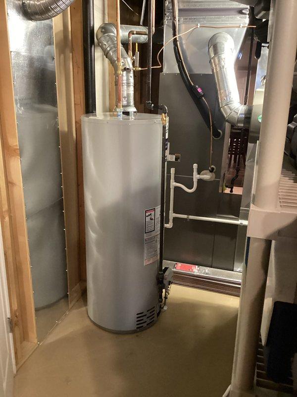 Completed installation of a 50-gallon tanked water heater in basement mechanical room. Removed existing unit and installed new water heater with proper venting configuration, connected copper supply and discharge piping with appropriate fittings and valves, and installed temperature and pressure relief valve with discharge piping per code requirements. Verified all plumbing connections for leaks, tested unit operation, and ensured proper clearances from adjacent HVAC equipment. Requested mechanical and plumbing permits for water heater installation and reconnection work.