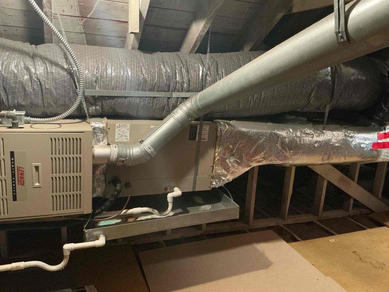 Provided estimate for complete HVAC system replacement in attic location, including air conditioning unit and furnace. Current 23-year-old equipment is still operational but nearing end of service life. Assessed existing horizontal furnace installation with associated ductwork, electrical connections, and condensate drainage system for proper replacement specifications. Customer inquired about available Lennox equipment promotions during consultation.