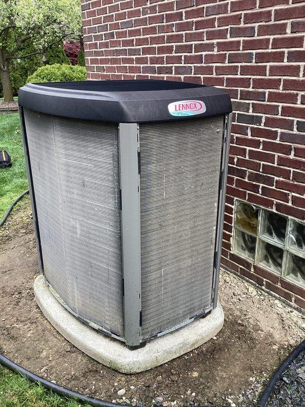 # HVAC Maintenance - ACM Completed

Performed comprehensive Air Care Cooling maintenance on Lennox residential cooling system. Conducted full system inspection of outdoor condenser unit positioned on concrete pad adjacent to building exterior. Unit found in good operating condition with no visible damage to cabinet, louvered panels, or protective top cover.

Verified thermostat operation and system controls. Lennox digital thermostat displaying proper communication with HVAC equipment, showing inside temperature of 72°F in cooling mode with setpoint of 65°F. Outside temperature reading of 54°F confirmed accurate sensor function. System actively cooling and responding appropriately to thermostat commands.

Inspected outdoor condensing unit components including cabinet integrity, louver condition, and mounting stability on concrete pad. Refrigerant lines and electrical connections examined for proper installation and absence of damage. No refrigerant leaks detected. All safety controls a
