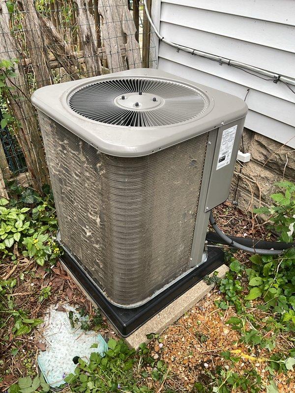 Completed annual cooling maintenance on residential air conditioning system. Performed comprehensive inspection of outdoor condenser unit, including visual assessment of cabinet condition, fan grille, and refrigerant line connections. Verified proper unit placement on drain pan and concrete pad. Replaced furnace filter as part of routine maintenance protocol. Inspected electrical conduit routing and manufacturer labeling. Unit operational and ready for cooling season.