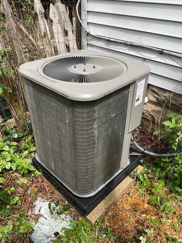 Completed annual cooling maintenance on residential air conditioning system. Performed comprehensive inspection of outdoor condenser unit, including visual assessment of cabinet condition, fan grille, and refrigerant line connections. Verified proper unit placement on drain pan and concrete pad. Replaced furnace filter as part of routine maintenance protocol. Inspected electrical conduit routing and manufacturer labeling. Unit operational and ready for cooling season.