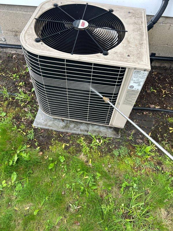 Completed annual cooling maintenance on residential outdoor condensing unit. Performed comprehensive inspection of condenser cabinet, coil, and fan assembly. Verified proper operation of condenser fan motor and checked fan blade condition. Inspected refrigerant lines for signs of wear or damage. Examined unit mounting and concrete pad for stability. Cleared debris and vegetation from around unit perimeter to ensure adequate airflow. Documented equipment condition with photographs showing weathered cabinet exterior with normal operational wear. Unit operating within normal parameters upon completion of maintenance visit.