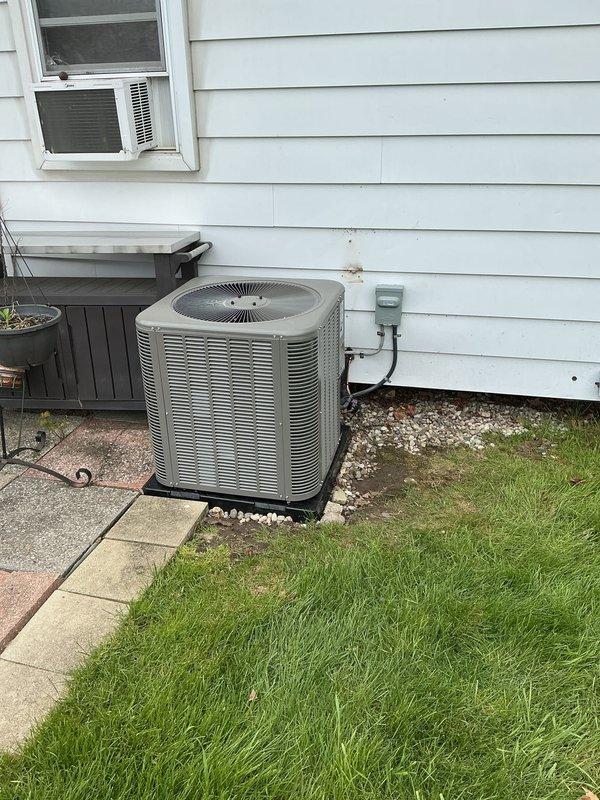Completed full HVAC system installation including a 70,000 BTU gas furnace, 2.5-ton air conditioning condenser unit positioned at rear of residence, and whole-home humidifier integration. Condenser unit mounted on rubber pad with proper gravel base, electrical disconnect box installed per code, and all refrigerant lines and electrical connections completed. Reconnected existing ductwork, verified all mechanical systems operational, and obtained necessary permits for installation compliance.