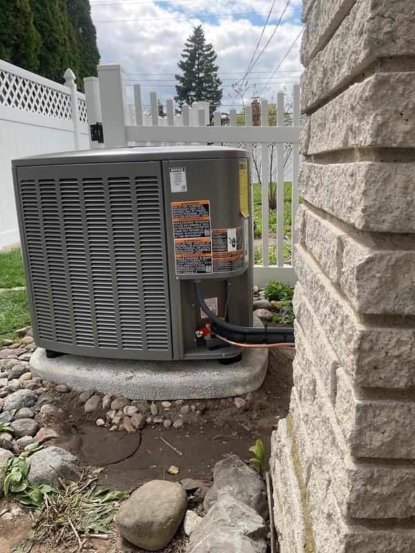 Completed full HVAC system installation including a 70,000 BTU gas furnace in the basement mechanical room and a 2.5-ton air conditioning condenser unit positioned on a concrete pad in the rear yard. Installed all necessary refrigerant line sets connecting the outdoor condenser to the indoor air handler, routed black flexible ductwork from furnace to existing distribution system, and connected white PVC condensate drainage piping. Mounted electrical disconnect box on perimeter fence adjacent to condenser unit, established all electrical connections, and reconnected gas supply line to furnace with proper shut-off valve. Completed all mechanical permits as required, performed system startup procedures, verified proper airflow and refrigerant charge levels, and confirmed all safety controls and thermostatic operations functioning within manufacturer specifications.
