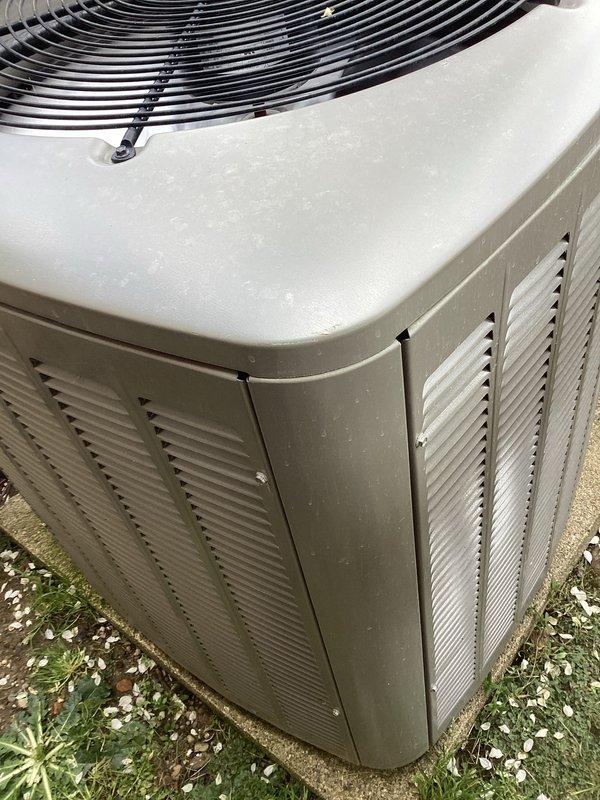 Completed routine air conditioning maintenance on residential outdoor condenser unit. Inspected condenser coil and noted moderate dust and debris accumulation on fins throughout the assembly. Documented unit condition with photos showing weathered cabinet exterior and dirt buildup on heat exchanger surfaces. All components appeared intact with no visible damage to coil fins or cabinet structure. Unit operational and positioned properly on concrete pad with adequate clearance for airflow.