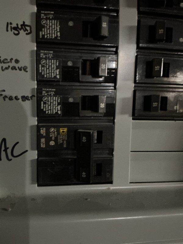 Responded to no-cooling call on 2-month-old system experiencing failure on first cooling call since installation. Upon arrival, verified thermostat calling for cooling and checked electrical panel breakers in on position with no power to outdoor unit. Inspected disconnect box at condensing unit and discovered two blown TR40 time-delay fuses. Replaced both failed fuses, restored power to system, and verified proper operation of condensing unit with compressor and condenser fan running normally. System now cooling properly with all components functioning as designed under warranty coverage.