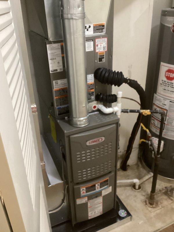 Completed full HVAC system installation including a Lennox 70,000 BTU furnace and 2-ton air conditioning unit. Installed furnace in interior utility room with proper ductwork connections, PVC condensate drainage, and ventilation; mounted outdoor AC condenser unit on exterior brick wall with electrical conduit and refrigerant line connections routed through wall penetrations. All equipment installed per manufacturer specifications with proper clearances, system tested and operational upon completion.