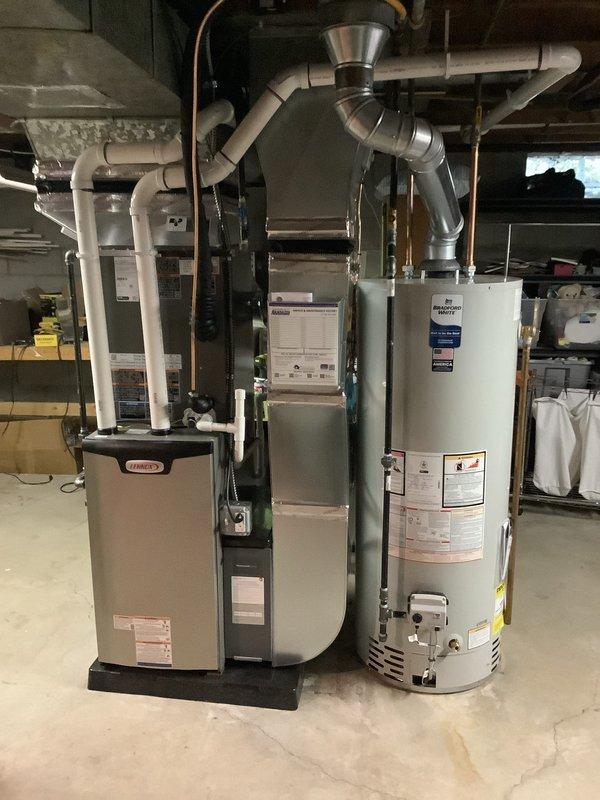 Completed full HVAC system replacement including installation of Lennox Elite Series 70,000 BTU gas furnace (model EL297UHVIX), 2.5 ton air conditioning unit with rear discharge configuration, humidifier, and hot water heater. All equipment professionally positioned in basement mechanical room with proper clearances for maintenance access. Installed complete PVC venting system, metallic ductwork connections, and copper refrigerant lines routed to ceiling. Reconnected all utilities and verified proper operation of entire system. Permits obtained prior to installation.