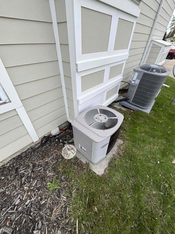 Provided estimate for complete HVAC system replacement in condominium utility room, including 2013 furnace and 1998 air conditioning system under BOGO promotion. Assessed existing equipment configuration with dual outdoor condenser units positioned on concrete pads and indoor furnace with water heater in compact mechanical space. Documented current system layout and specifications to prepare comprehensive replacement proposal for aging cooling system while existing furnace remains operational.