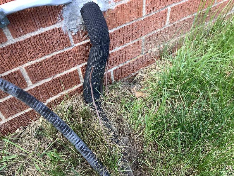 Responded to service call for outdoor AC unit with damaged wire from lawn maintenance activity. Upon inspection, located severed low-voltage wire near unit base where electrical conduit runs along foundation. Repaired damaged conductor, verified proper wire gauge and connections, and restored wiring integrity. Inspected condenser coil and noted accumulated debris and minor fin damage requiring future cleaning and maintenance. Unit currently offline due to seasonal conditions; recommended functional testing when cooling season resumes to confirm proper operation of all electrical components and system performance.