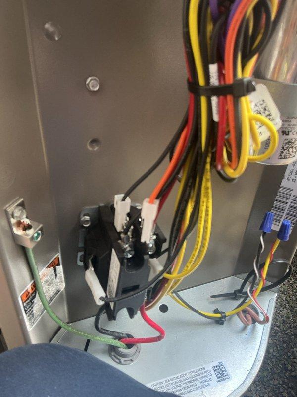 Responded to service call for recently installed central air conditioning system experiencing ratcheting noise and non-functional outdoor fan upon AC activation. Inspected electrical connections at control board and verified proper wire terminations and relay operation. Diagnosed failed condenser fan motor capacitor preventing fan startup, causing the audible ratcheting sound from compressor attempting to cycle. Replaced defective dual run capacitor with manufacturer-specified component and secured all electrical connections. Tested system operation through complete cooling cycle, confirming proper condenser fan rotation, normal compressor operation, and elimination of mechanical noise. System restored to full cooling functionality.