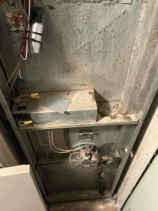 Provided estimate for complete HVAC system replacement at residential property with non-functional 1992 furnace located in front section of home. Assessed existing aged heating unit showing significant wear, deterioration, and operational failure, with no air conditioning system currently installed. Documented equipment condition and installation location to prepare comprehensive replacement proposal for new furnace and air conditioning system.