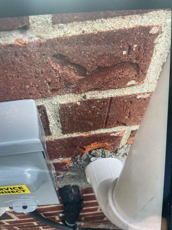 Responded to callback regarding oil residue on brick paver patio from previous condenser removal. Procured cleaning supplies and successfully removed oil stains from pavers. Verified proper installation of 70,000 BTU furnace, 2.5-ton rear-discharge air conditioning system, humidifier, and all reconnections. Confirmed A/C service disconnect box and condensate drain line properly mounted to exterior brick wall per code requirements.