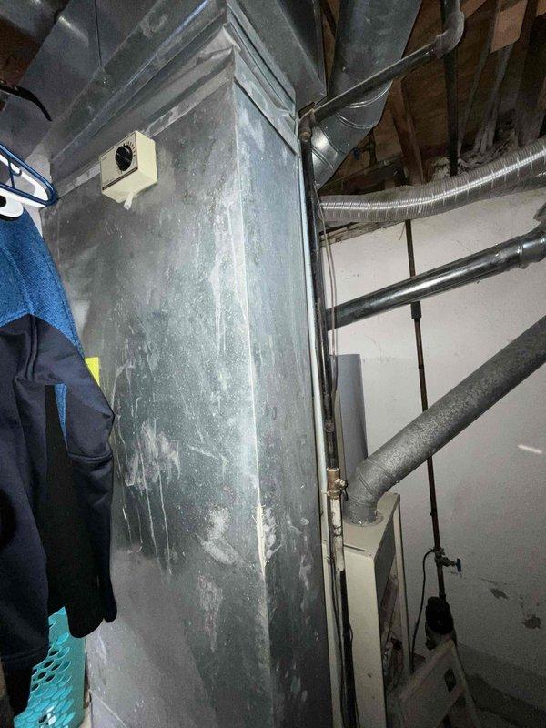 Provided comprehensive estimate for complete HVAC system replacement in basement location, including both furnace and air conditioning units. Existing 42-year-old equipment assessed as unsafe and non-operational, with air conditioning system currently inoperable and furnace displaying hazardous conditions including significant moisture accumulation on ductwork and metal components. Recommended immediate replacement of natural gas furnace and central air conditioning system due to age, safety concerns, and system failure.