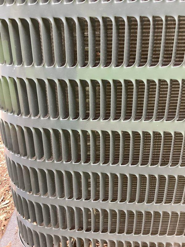 # HVAC Maintenance - AHC Completed

Performed comprehensive annual tune-up on residential central air conditioning system. Conducted full system inspection of outdoor condenser unit, which displayed operational status with normal function. Observed bent condenser fins on heat exchanger coil affecting airflow efficiency, along with moderate corrosion present on base mounting frame. Documented unit condition through photographic records showing fin damage patterns and weathering on exterior components. Completed standard maintenance protocol including visual inspection of condenser assembly, coil examination, and assessment of mounting hardware integrity. System confirmed operational despite cosmetic deterioration and minor fin distortion. Recommended monitoring fin condition for potential future straightening to optimize heat transfer efficiency.