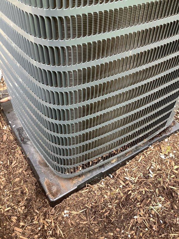 # HVAC Maintenance - AHC Completed

Performed comprehensive annual tune-up on residential central air conditioning system. Conducted full system inspection of outdoor condenser unit, which displayed operational status with normal function. Observed bent condenser fins on heat exchanger coil affecting airflow efficiency, along with moderate corrosion present on base mounting frame. Documented unit condition through photographic records showing fin damage patterns and weathering on exterior components. Completed standard maintenance protocol including visual inspection of condenser assembly, coil examination, and assessment of mounting hardware integrity. System confirmed operational despite cosmetic deterioration and minor fin distortion. Recommended monitoring fin condition for potential future straightening to optimize heat transfer efficiency.
