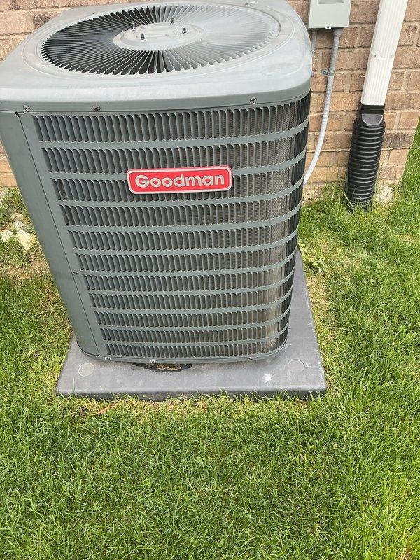 Completed scheduled maintenance on Goodman brand outdoor condensing unit. Performed standard ACM protocol including inspection of condenser coils, fan motor operation, refrigerant lines, and electrical connections. Unit found in good working condition with clean coils, proper airflow through louvered intake grilles, and no visible signs of wear, damage, or refrigerant leaks. Verified secure mounting on concrete pad and confirmed all components operating within normal parameters.