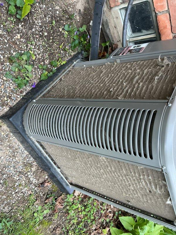 Completed seasonal AC tune-up on 5-year-old Lennox system. System was operating properly upon arrival. Performed comprehensive maintenance including inspection of outdoor condenser unit, verified proper airflow through louvered grille and intake panels, checked refrigerant levels, tested electrical connections, and cleaned accessible components. Unit showed normal wear for age with minor dust accumulation on top surfaces. Condenser positioned on concrete pad with adequate clearance from building structure. All operational parameters within manufacturer specifications. System left in optimal working condition for cooling season.