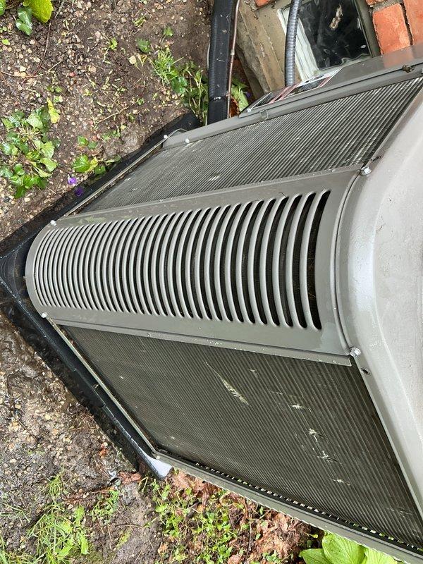 Completed seasonal AC tune-up on 5-year-old Lennox system. System was operating properly upon arrival. Performed comprehensive maintenance including inspection of outdoor condenser unit, verified proper airflow through louvered grille and intake panels, checked refrigerant levels, tested electrical connections, and cleaned accessible components. Unit showed normal wear for age with minor dust accumulation on top surfaces. Condenser positioned on concrete pad with adequate clearance from building structure. All operational parameters within manufacturer specifications. System left in optimal working condition for cooling season.