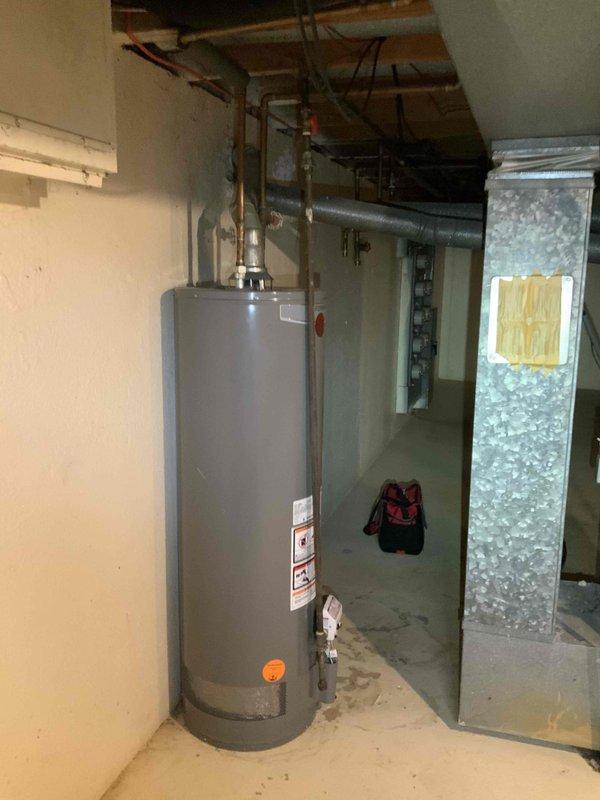 Conducted comprehensive HVAC replacement estimate for 20-30 year old basement system with non-operational air conditioning unit and functioning natural gas furnace. Documented existing ductwork configuration including 8x14 supply trunk line and 8x21 return trunk line with right return orientation, assessed plenum layout and clearances around existing equipment including water heater proximity, and photographed current installation conditions to provide accurate replacement specifications for new furnace and air conditioning system.