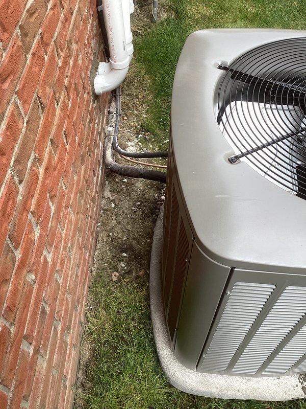 Completed full HVAC system installation including a 70,000 BTU furnace and 2.5-ton air conditioning unit in basement location with left-side configuration. Installed outdoor condenser unit on concrete pad adjacent to building exterior with copper refrigerant lines wrapped in foam insulation and PVC condensate drain line routed along brick wall. Reconnected all electrical connections and completed mechanical hookups per specifications. Requested and coordinated mechanical and electrical permits for the installation. Set up utility rebate processing documentation for DTE and SEMCO Energy programs.