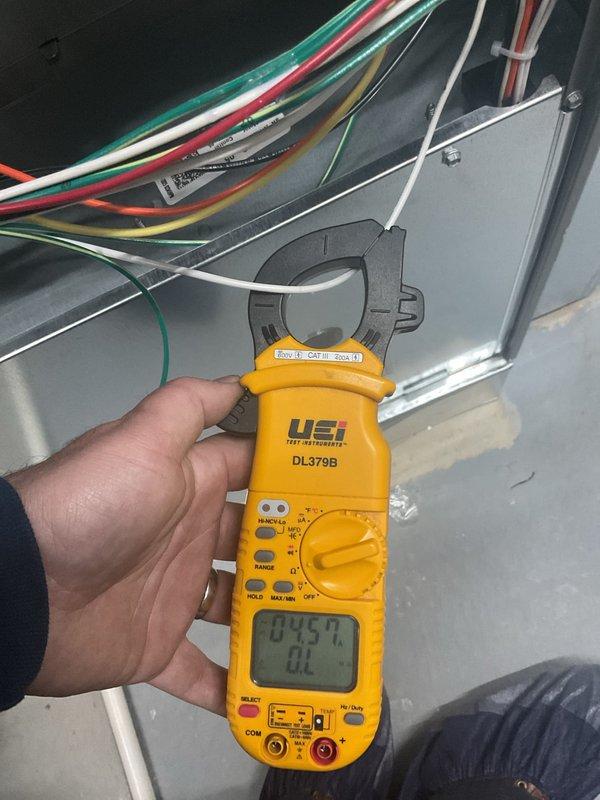 Completed annual cooling maintenance on HVAC system. Replaced humidifier pads and air filters as part of scheduled preventative maintenance. Measured operating amperage at 104.57A using clamp meter to verify compressor performance within normal parameters. Inspected outdoor condenser unit and noted coil fins showing accumulation of dirt and debris with visible darkening and discoloration, though unit remained operational. All electrical connections checked and found secure.
