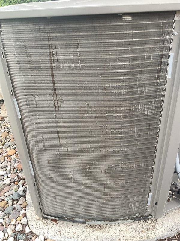 Completed annual cooling maintenance on HVAC system. Replaced humidifier pads and air filters as part of scheduled preventative maintenance. Measured operating amperage at 104.57A using clamp meter to verify compressor performance within normal parameters. Inspected outdoor condenser unit and noted coil fins showing accumulation of dirt and debris with visible darkening and discoloration, though unit remained operational. All electrical connections checked and found secure.