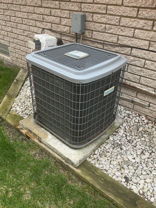 Completed comprehensive tune-up on 17-year-old residential furnace system and exterior condensing unit. Performed standard maintenance protocol including inspection of all mechanical components, electrical connections, and safety controls. Unit operational and positioned properly on concrete pad with adequate clearance from structure; outdoor condenser showing normal wear consistent with age and functional at time of service.