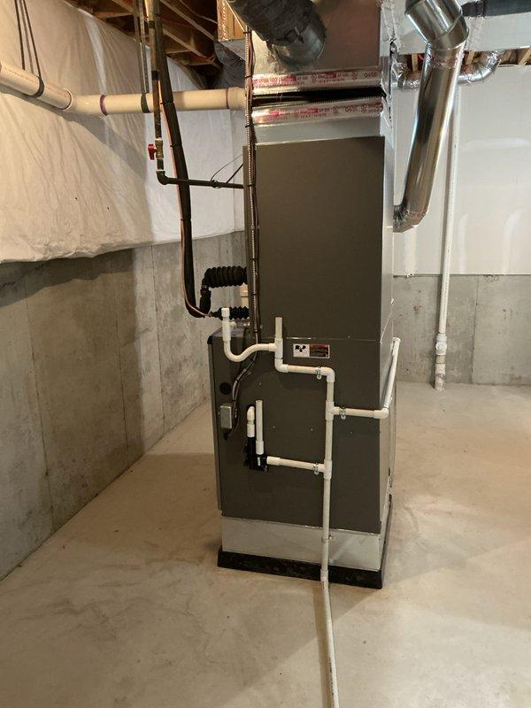 Completed full HVAC system installation including 132,000 BTU furnace, 5-ton air conditioning unit, and humidifier in basement mechanical room. Installed all necessary ductwork, refrigerant lines, condensate drainage piping with exterior PVC routing, and electrical connections. Secured mechanical and electrical permits, reconnected all system components, and verified proper operation of complete heating and cooling system.