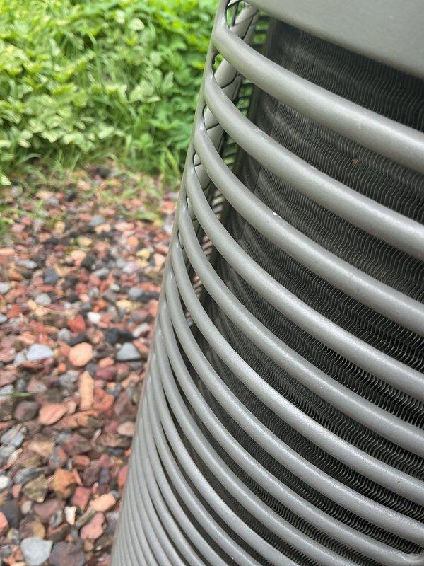 Completed comprehensive AC tune-up on 10-year-old system. Performed full maintenance inspection including evaluation of condenser coil and heat exchanger fins, verified proper operation of all components, and documented system condition with photographs. Unit operating within normal parameters with clean coil surfaces and intact protective grille assembly.