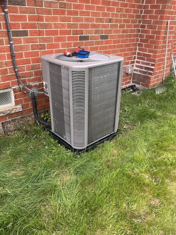Performed comprehensive AC tune-up on outdoor condenser unit positioned against building exterior. Completed standard maintenance protocol including inspection of all accessible components, cleaning of condenser coils and exterior surfaces, verification of proper airflow through louvers and grilles, and operational testing to confirm system functionality. Unit operating within normal parameters with no issues identified; customer informed that furnace maintenance should be scheduled for fall season.