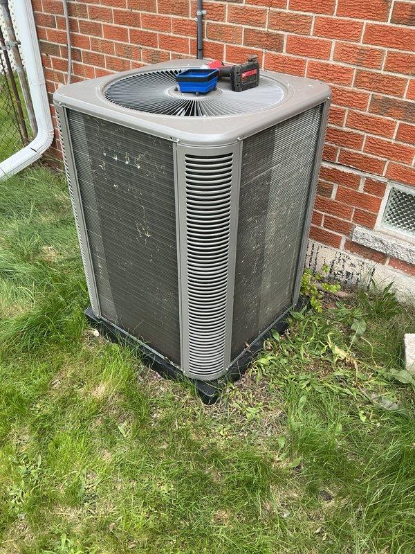 Performed comprehensive AC tune-up on outdoor condenser unit positioned against building exterior. Completed standard maintenance protocol including inspection of all accessible components, cleaning of condenser coils and exterior surfaces, verification of proper airflow through louvers and grilles, and operational testing to confirm system functionality. Unit operating within normal parameters with no issues identified; customer informed that furnace maintenance should be scheduled for fall season.