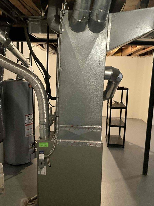 Completed HVAC equipment assessment for replacement estimate on non-functioning 20-year-old air conditioning system and natural gas furnace located in basement mechanical room. Evaluated existing air handler unit, ductwork infrastructure including flexible and rigid metal ducts, electrical panel capacity with 30895 service number, and overall system configuration to provide comprehensive replacement recommendations for aging equipment that has reached end of service life.