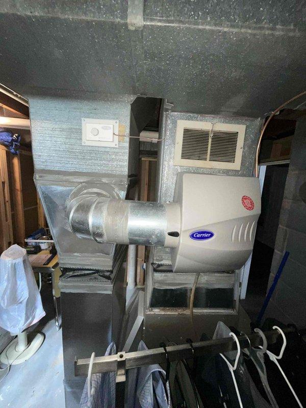 Conducted on-site evaluation for complete HVAC system replacement in basement installation. Assessed existing 14-year-old natural gas furnace and non-operational air conditioning unit, including inspection of Carrier humidifier, ductwork, and air handler configuration. Documented current equipment conditions, measured existing plenum and supply duct specifications, and provided comprehensive replacement estimate for new heating and cooling system.