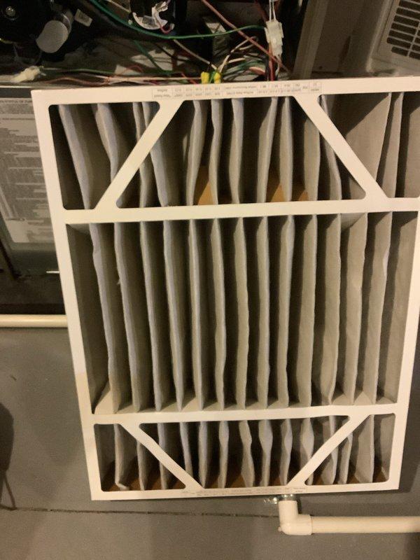 Completed annual cooling maintenance on three air conditioning systems per service agreement. Inspected and replaced air filters showing dust accumulation on all units. Verified proper filter installation with diagonal cross-bracing support frames. Documented filter conditions and system components with photographic evidence. System operational following routine maintenance procedures.