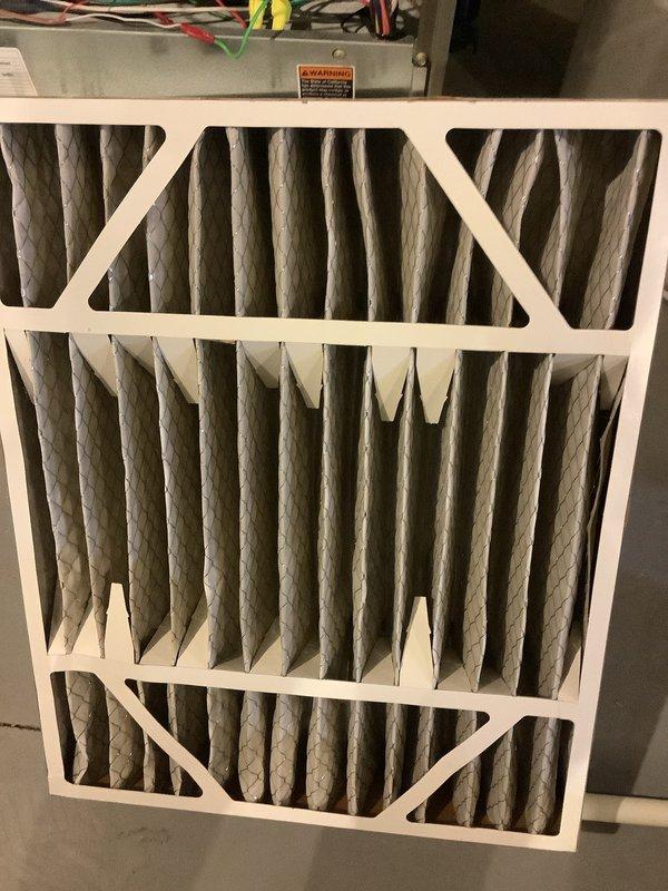 Completed annual cooling maintenance on three air conditioning systems per service agreement. Inspected and replaced air filters showing dust accumulation on all units. Verified proper filter installation with diagonal cross-bracing support frames. Documented filter conditions and system components with photographic evidence. System operational following routine maintenance procedures.