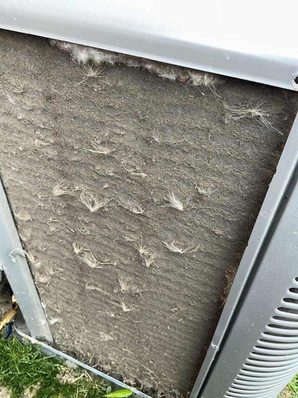 Completed annual HVAC maintenance inspection on outdoor condensing unit. Documented heavily soiled air filter with significant dust and debris accumulation, as well as condenser coil with dirt, organic matter, and oxidation buildup between fins. Unit operational with noted maintenance needs for filter replacement and coil cleaning to maintain optimal system efficiency.