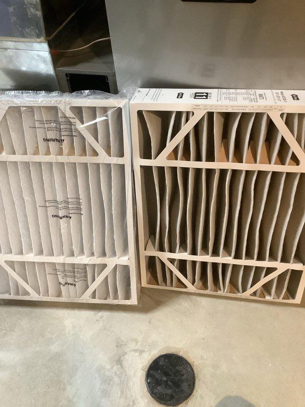 Completed annual cooling maintenance on residential air conditioning system. Inspected outdoor condenser unit, noting weathering and organic buildup on coil fins; cleaned exterior surfaces to restore proper airflow. Replaced dirty air filter with new unit, as evidenced by significant dust and debris accumulation on old filter. Verified system operation and documented equipment condition through photographic records.