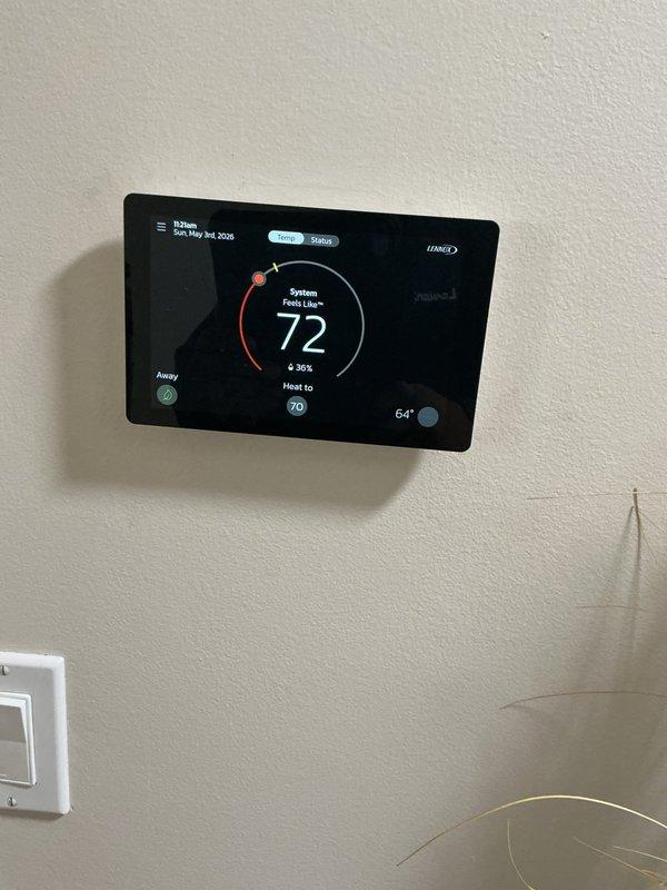Completed routine air conditioning maintenance on residential split system. Verified thermostat operation and temperature calibration, confirmed system cycling properly in cooling mode. Inspected and assessed air handler filter condition, checked condensate drain line and trap for proper operation, and examined refrigerant line connections for integrity. All components found operating within normal parameters with no deficiencies noted.