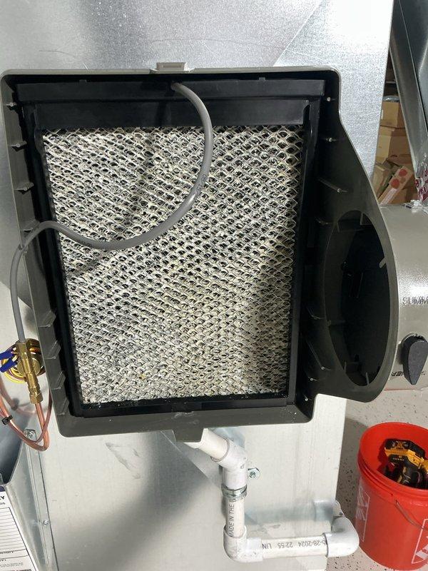Completed routine air conditioning maintenance on residential split system. Verified thermostat operation and temperature calibration, confirmed system cycling properly in cooling mode. Inspected and assessed air handler filter condition, checked condensate drain line and trap for proper operation, and examined refrigerant line connections for integrity. All components found operating within normal parameters with no deficiencies noted.