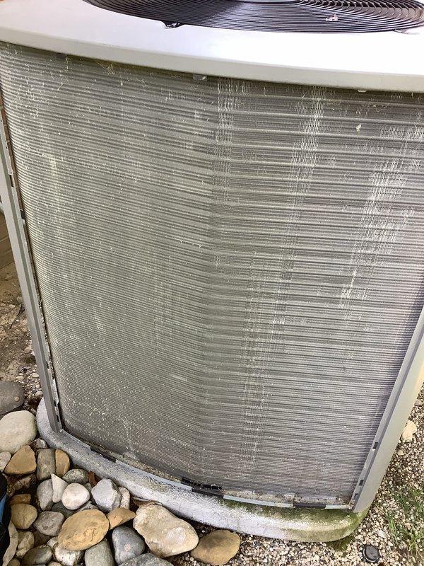Completed annual cooling maintenance on residential air conditioning system. Performed system diagnostics and measurements, documented outdoor condenser unit condition showing debris accumulation and bent fins on coil requiring attention, and verified operational parameters. Unit operational at time of service completion.