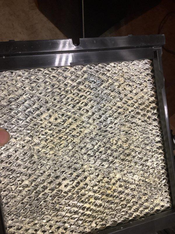 Completed scheduled Air Care Maintenance on residential air conditioning system. Inspected and documented condition of air filtration components, noting moderate dust and debris accumulation on honeycomb-style filter media and secondary filter element. Both filters showed normal dirt loading consistent with regular system operation. Verified filter frames were properly seated and secured within HVAC unit housing. Examined system components including refrigerant lines and valve connections, confirming all warning labels were intact and legible.