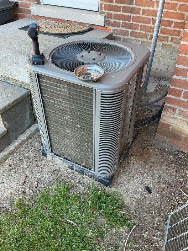 Completed scheduled maintenance on residential outdoor air conditioning condenser unit. Performed standard ACM (air conditioning maintenance) protocol including inspection of fan assembly, louvers, and exterior housing. Unit operational and positioned properly on concrete pad with refrigerant lines secured.