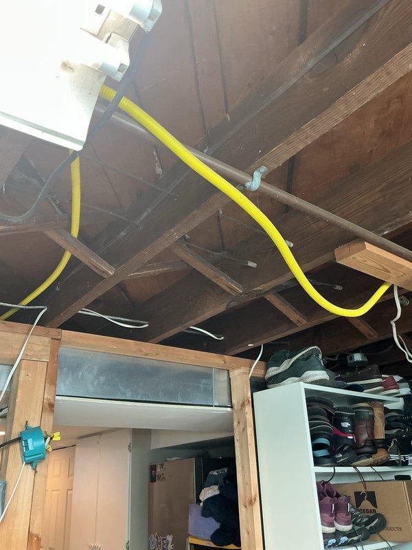 Responded to water leak issue in basement caused by improperly installed condensate pump from previous HVAC installation. Inspected condensate drainage system with multiple PVC lines running vertically along furnace unit and determined pump discharge line requires rerouting from exterior to utility sink near washer to resolve drainage problems. Additionally assessed temperature distribution concerns throughout residence and performed air conditioning maintenance as time permitted, noting system is three years old and covered under parts warranty only.
