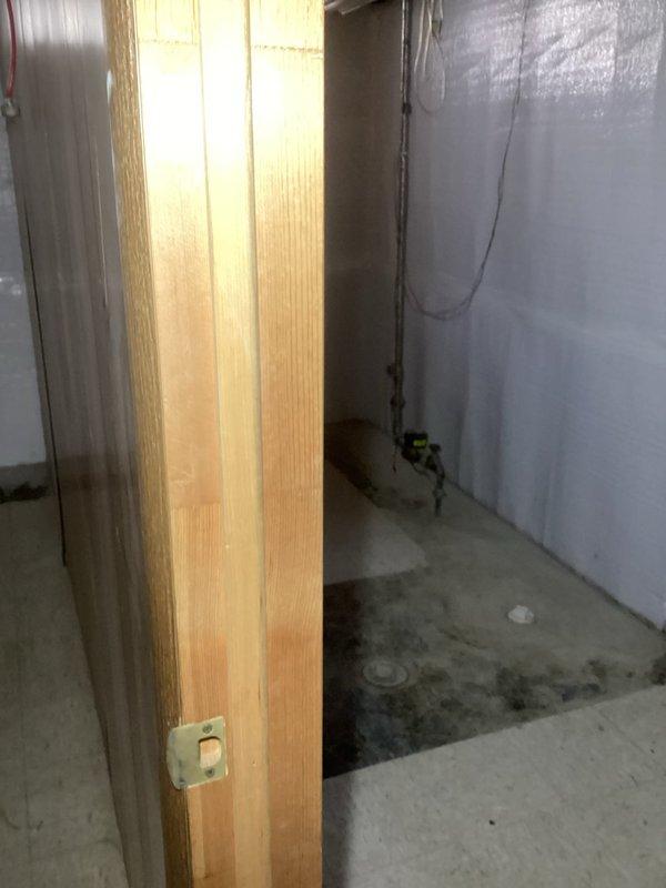 Conducted electrical panel inspection in basement to evaluate scorched wiring conditions identified during pre-purchase home inspection. Upon examination of the main electrical service panel, assessed visible scorching on wires and panel components to determine fire hazard severity and identify root cause of overheating. Documented panel condition with photographic evidence showing open breaker box and surrounding electrical infrastructure in unfinished basement area with reflective insulation installation. Provided professional assessment of necessary corrective actions required to address potential fire safety concerns and restore panel to code-compliant operating condition.