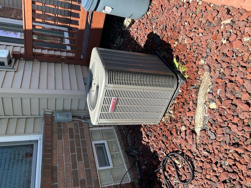 Completed comprehensive ComfortShield preventive maintenance on two outdoor condensing units at residential property. Performed thorough inspection of both systems, including visual assessment of condenser coils, fan operation, electrical connections, and refrigerant lines. Cleared debris and organic material from unit tops and surrounding areas, verified proper airflow through condenser coils, and confirmed both units were operating within normal parameters. All components found in satisfactory working condition with no immediate service needs identified.