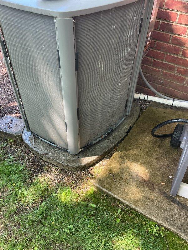 Completed annual cooling maintenance on outdoor condensing unit. Performed comprehensive inspection of residential air conditioning system including visual assessment of cabinet condition, grille integrity, and unit placement on concrete pad. Verified proper clearances around equipment and checked for any visible damage or deterioration to exterior components. Inspected condenser coils through protective mesh grilles and assessed overall system accessibility for service. Documented current equipment condition showing normal weathering consistent with outdoor installation. Unit operational with no immediate service concerns identified during maintenance visit.