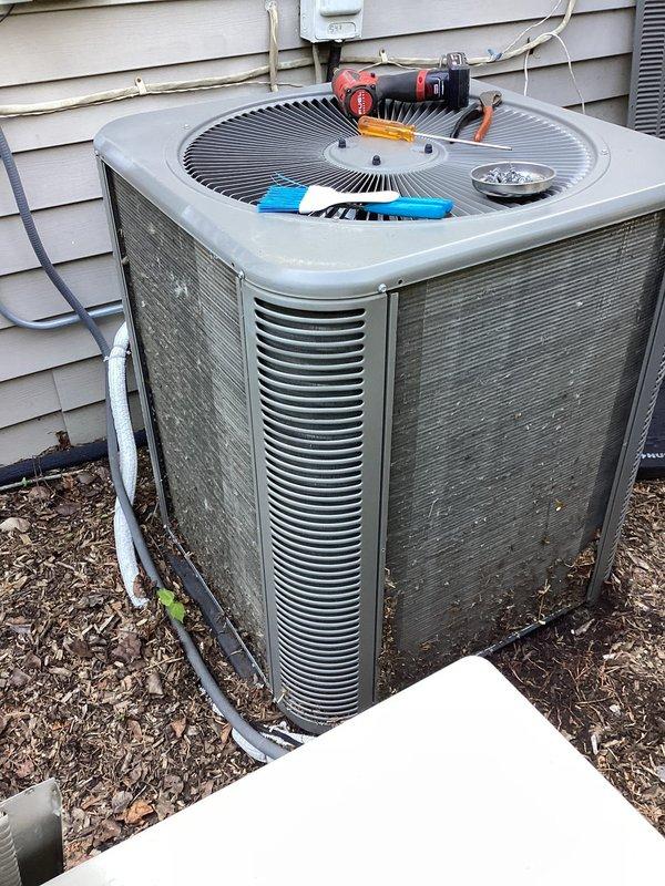 Performed routine maintenance on residential air conditioning condenser unit. Inspected heat exchanger coils and noted debris accumulation between aluminum fins. Cleaned condenser coils, checked refrigerant lines and electrical connections, and verified proper operation of fan assembly and ventilation louvers.