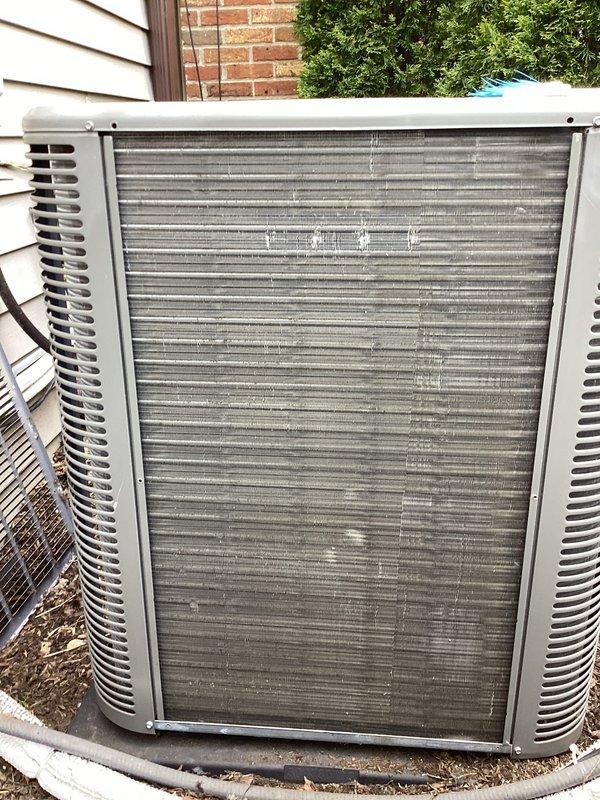 Performed routine maintenance on residential air conditioning condenser unit. Inspected heat exchanger coils and noted debris accumulation between aluminum fins. Cleaned condenser coils, checked refrigerant lines and electrical connections, and verified proper operation of fan assembly and ventilation louvers.